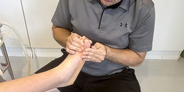 Podiatrist Luke Simpson of Sports & Injury Management, Diamond Creek with a patient