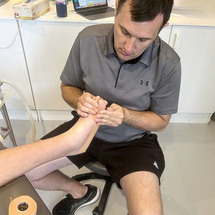 Podiatrist Luke Simpson of Sports & Injury Management, Diamond Creek with a patient